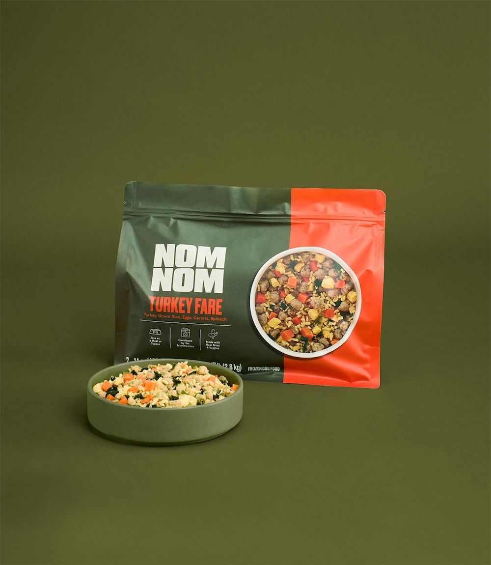 A dog eats a Turkey Fare meal from a bowl